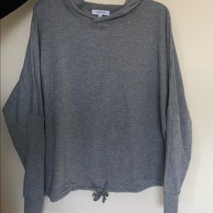 Hoodie with a string through the front to adjust waist size! Easy to match with